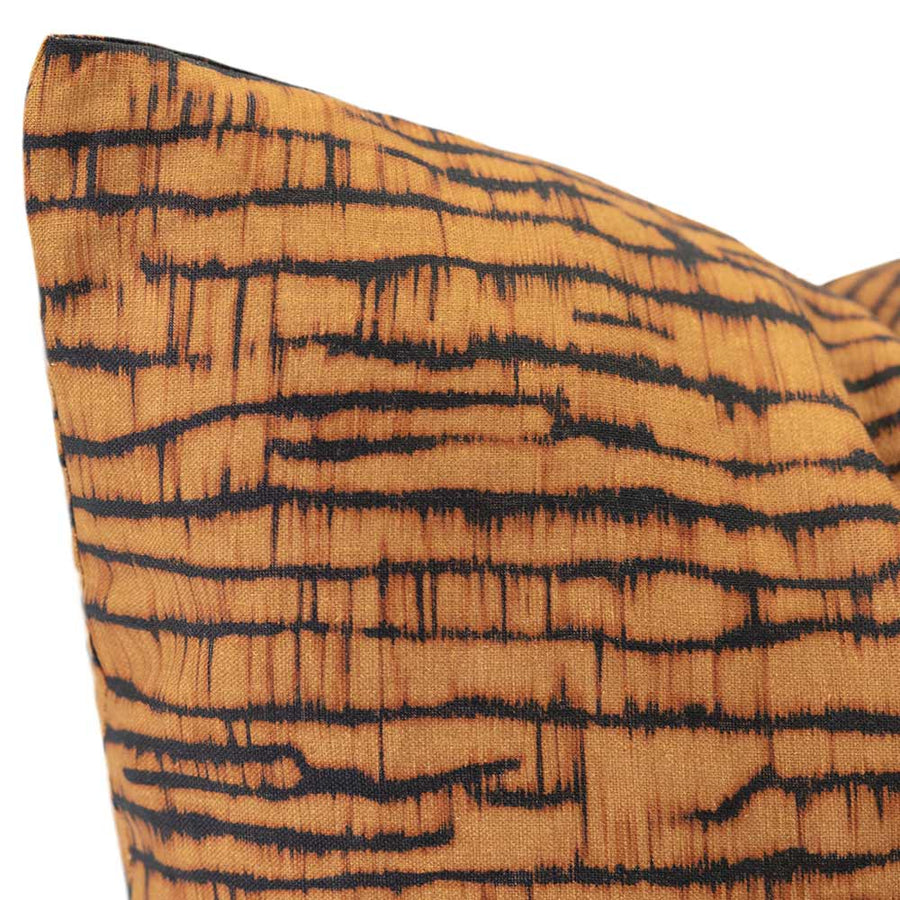 Cushion from the Tim Neve collection by Urban Road, featuring a golden bark-like linear pattern on a deep charcoal background.