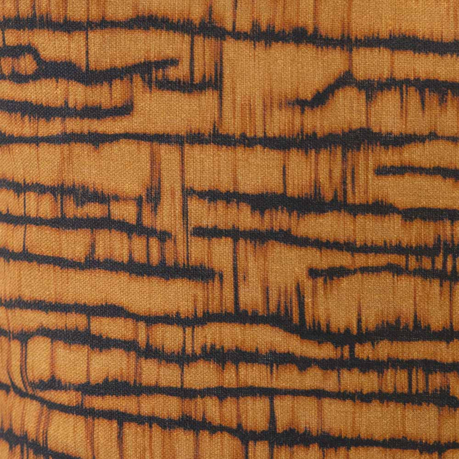 Cushion from the Tim Neve collection by Urban Road, featuring a golden bark-like linear pattern on a deep charcoal background.