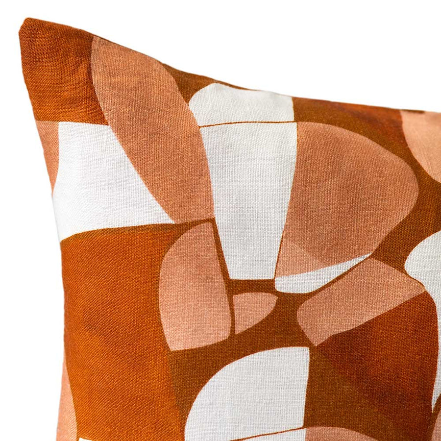 Cushion from the Tim Neve collection by Urban Road, featuring a golden patchwork design with organic curved shapes in neutral hues.
