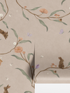 Taupe wallpaper of trailing branches with tiny rabbits, blossoms and birdhouses, from the Little Tails Collection by Urban Road.