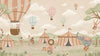 Pastel circus fair with hot air balloons, striped tents and playful animal performers, from the Little Tails Collection by Urban Road.