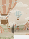 Pastel circus fair with hot air balloons, striped tents and playful animal performers, from the Little Tails Collection by Urban Road.