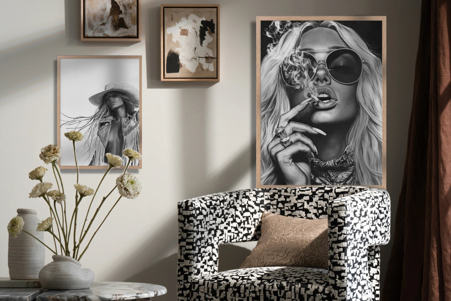 Monochrome portraits and abstract art above a patterned black-and-white chair in a stylish, moody corner.