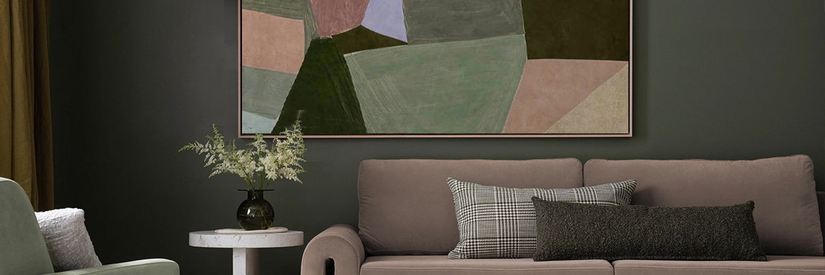 Sophisticated living space featuring bold abstract art with geometric shapes and rich, earthy tones above a sleek sofa.