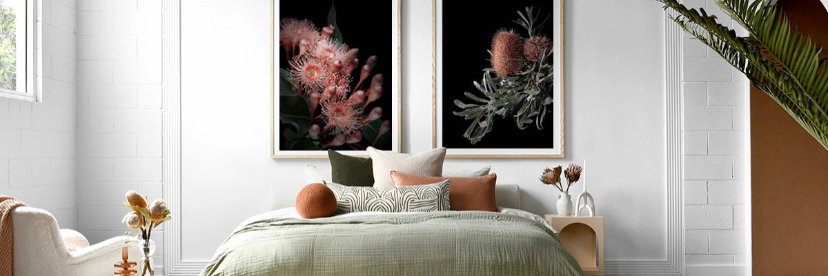 Relaxing bedroom interior showcasing Australiana-themed botanical artworks in vibrant colours above a serene bed setup.