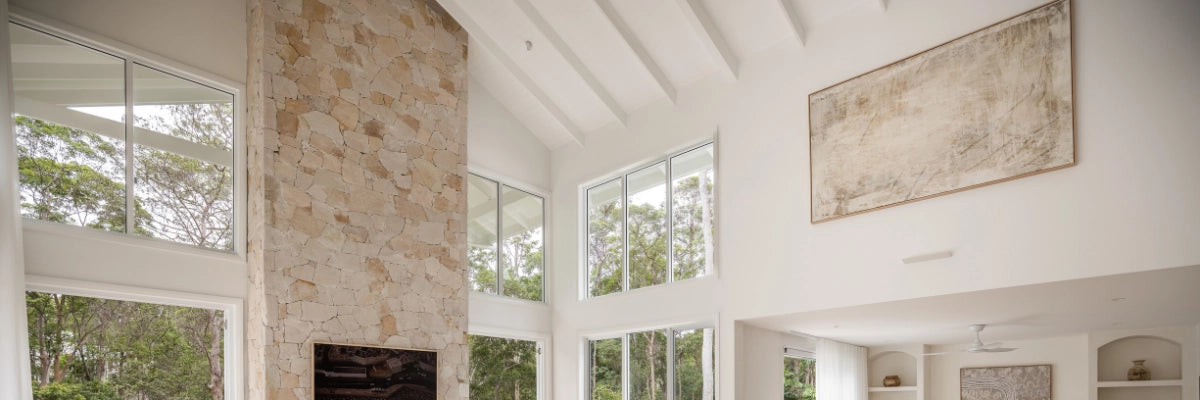 Spacious open-plan living area featuring oversized abstract art pieces in neutral tones, complementing a sophisticated decor.